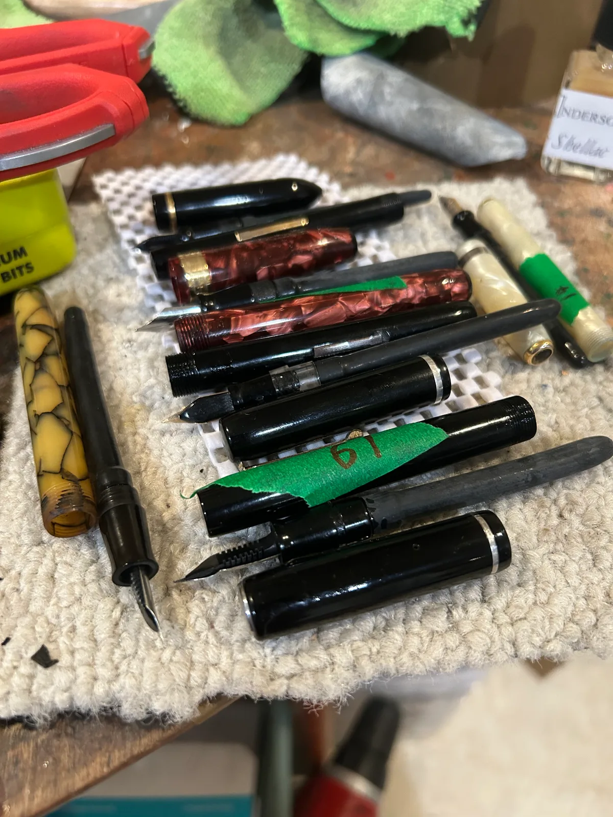Pens apart: nibs, sections and barrels laid out for cleaning