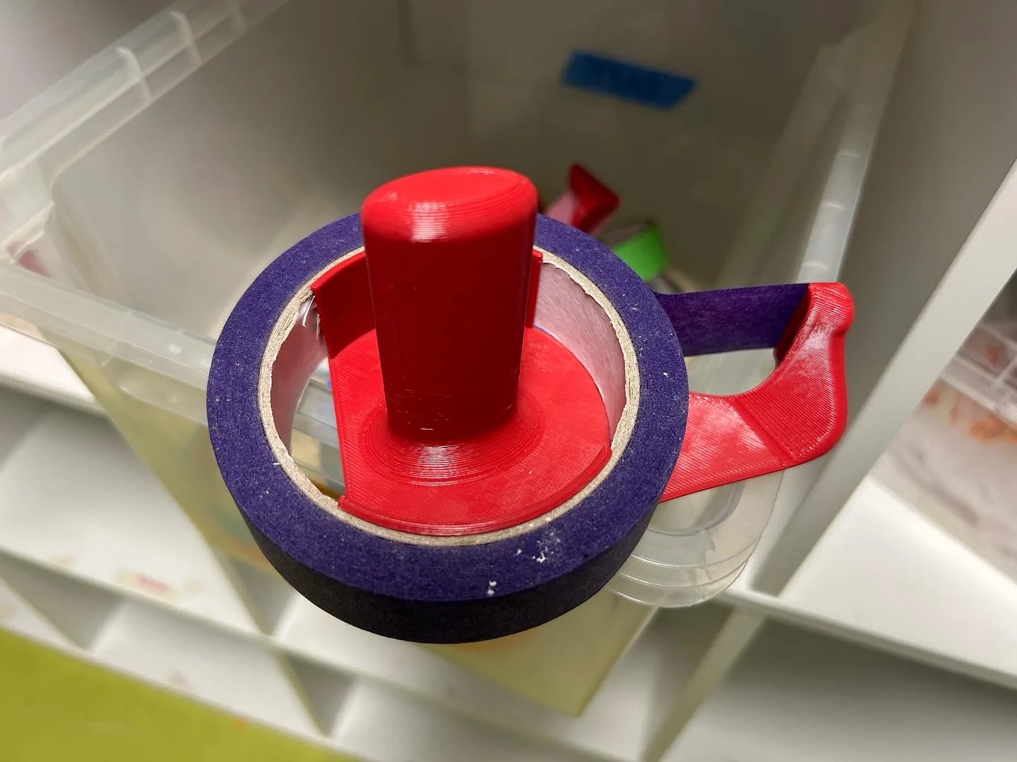 Loaded with a roll of masking tape, run out to the tear tip