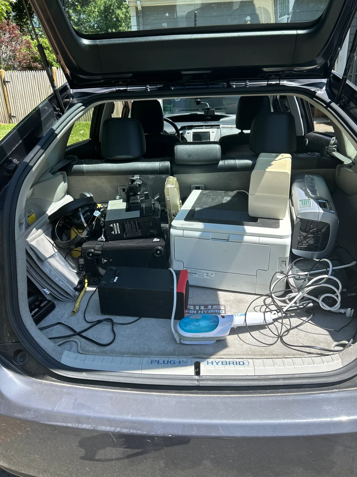 A trunk load of old printers and electronics from the recycling center, headed for take-apart sessions