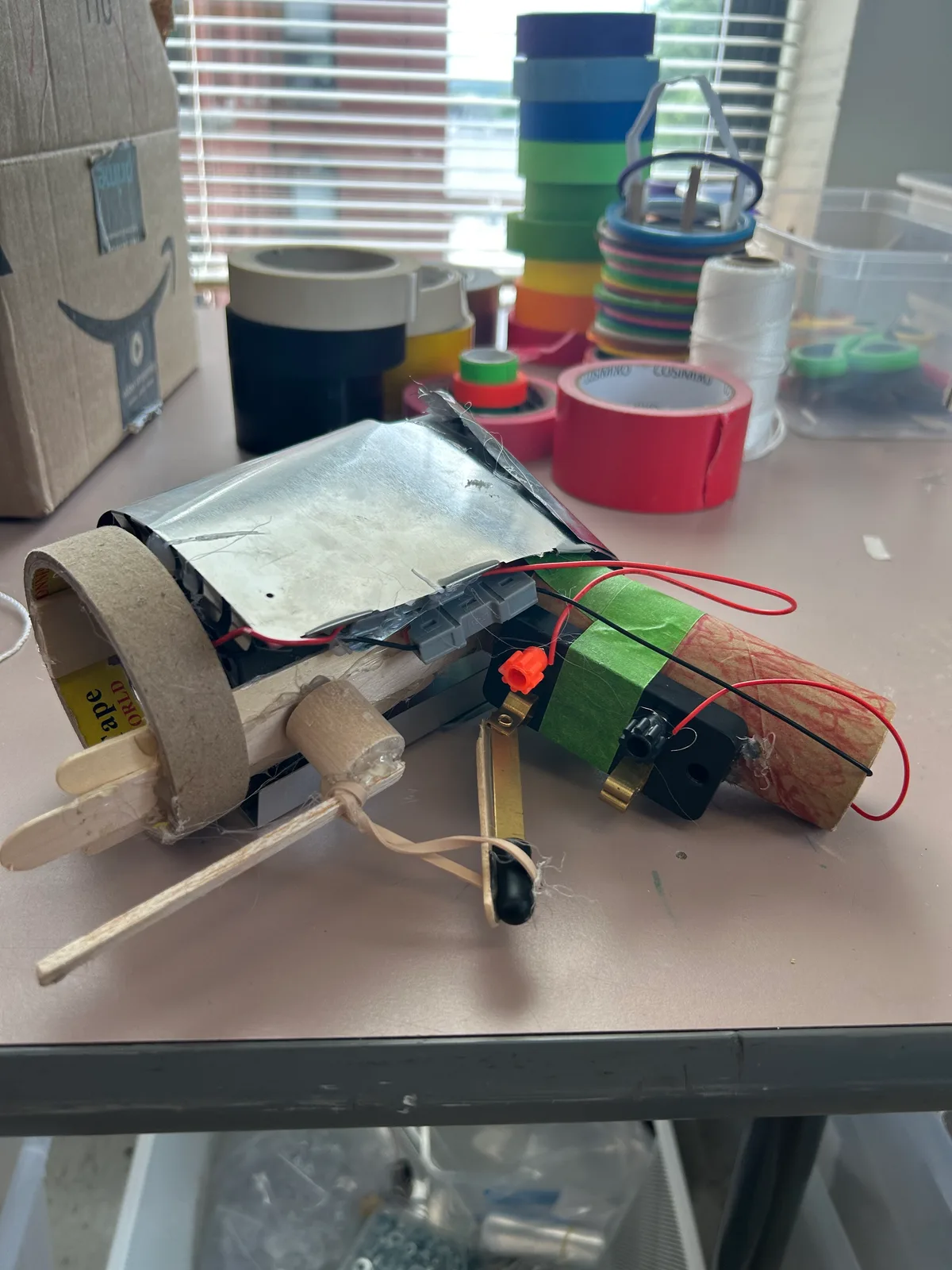 A cardboard launcher wired to a salvaged motor and switch