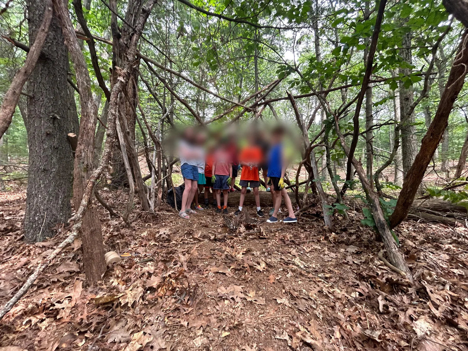 The finished stick fort with its builders
