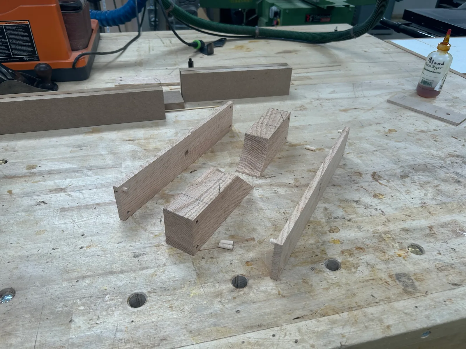 Cheeks and center blocks after the bandsaw cut, with dowel pins to register them at glue-up