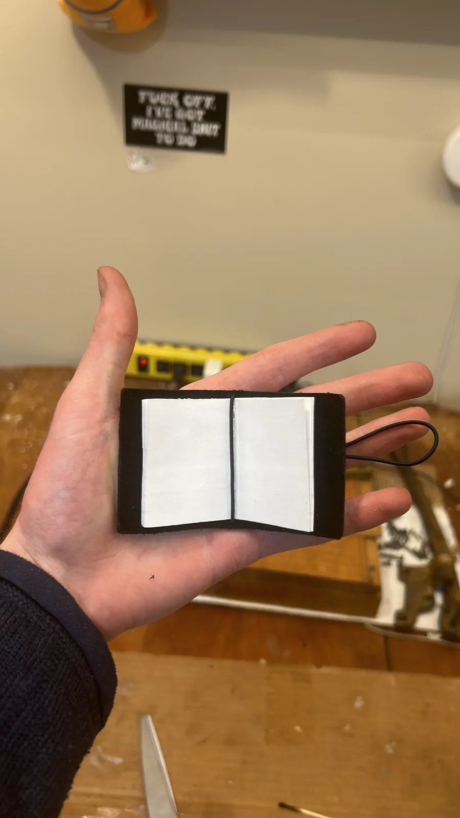 Pocket sketchbook open in hand