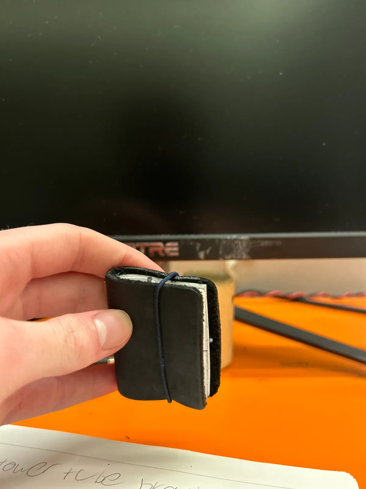 Closed, held shut by its elastic band