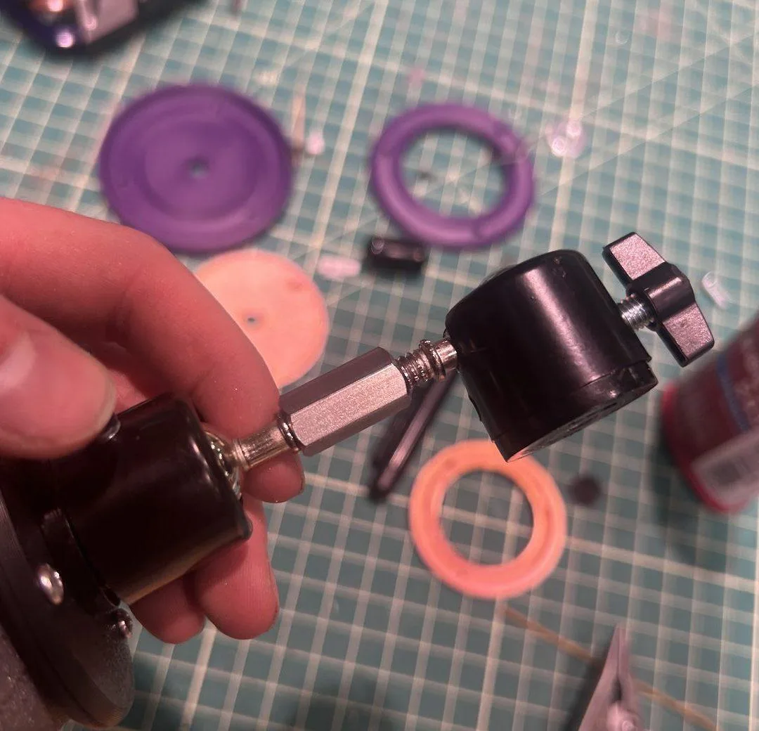 Two ball heads joined by a coupling nut, blue Loctite on every thread