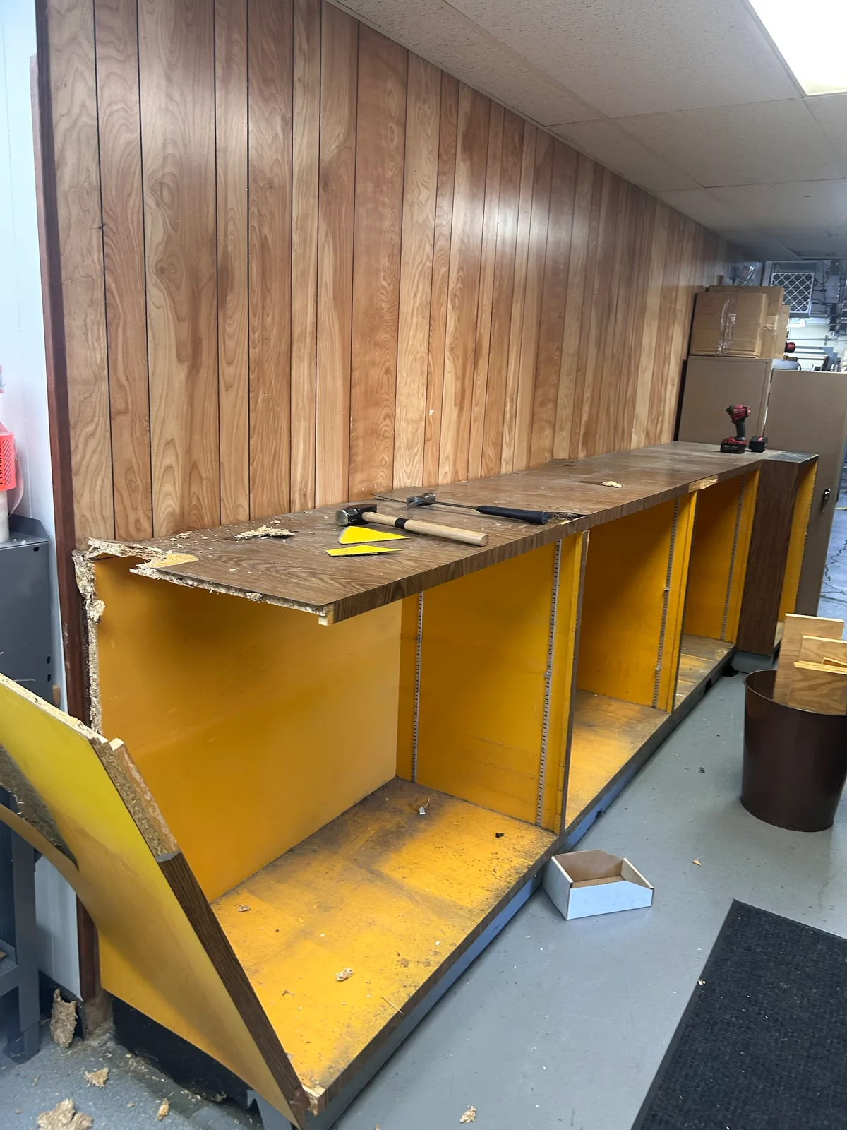 Taking apart the built-in cabinet and counter in the hallway to open the route through the shop.