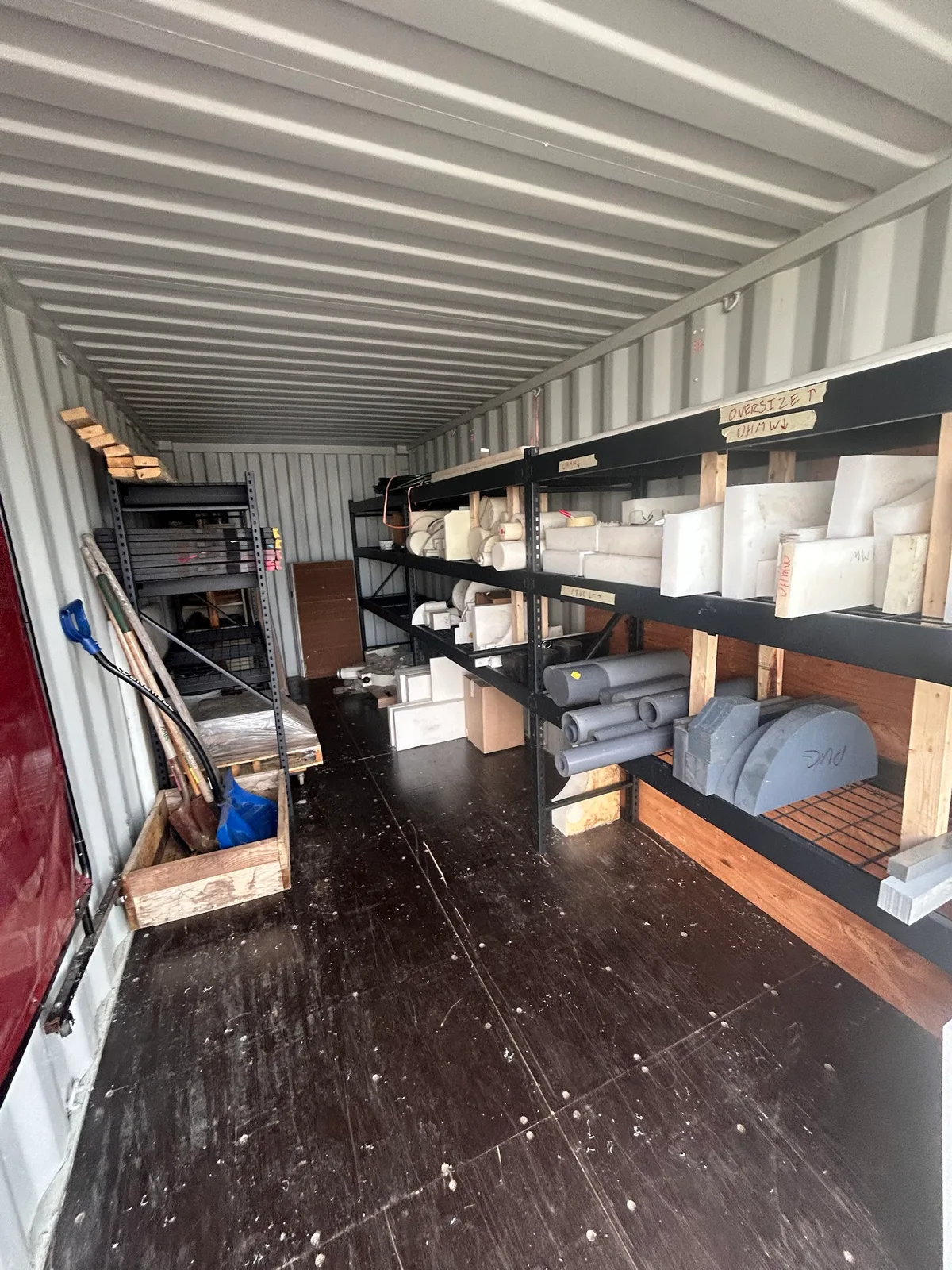 Where the plastic stock went: a storage container outside the shop. I added the shelving and labeled it by material and size (UHMW, PVC, oversize) so it stays findable.