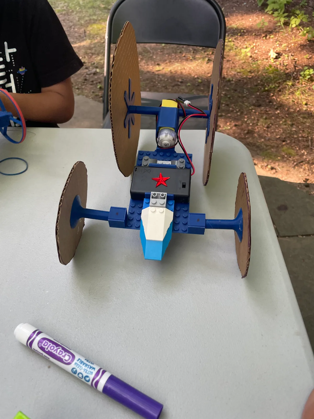 A customized car: cardboard wheels on the pop-on hubs, decorations on the LEGO-compatible studs